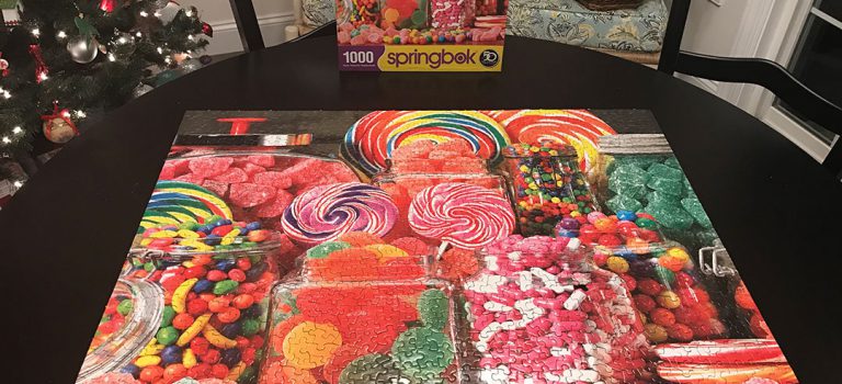 A completed puzzle with different candies printed on it.