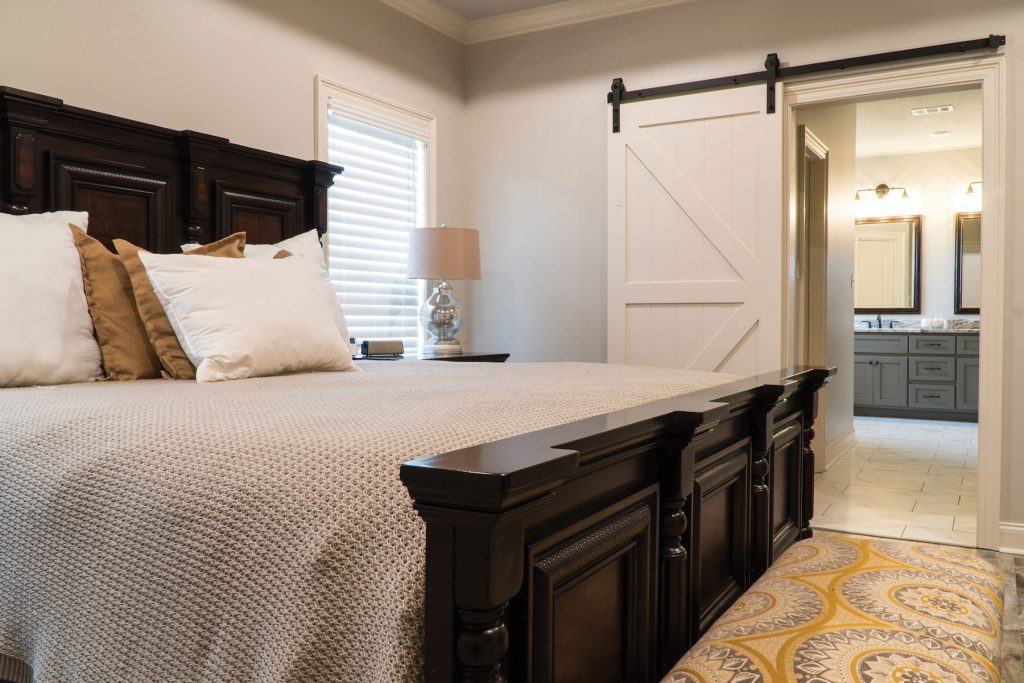 bedroom with barn door into bathroom