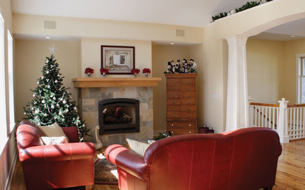 A living room with red furniture and a Christmas Tree.