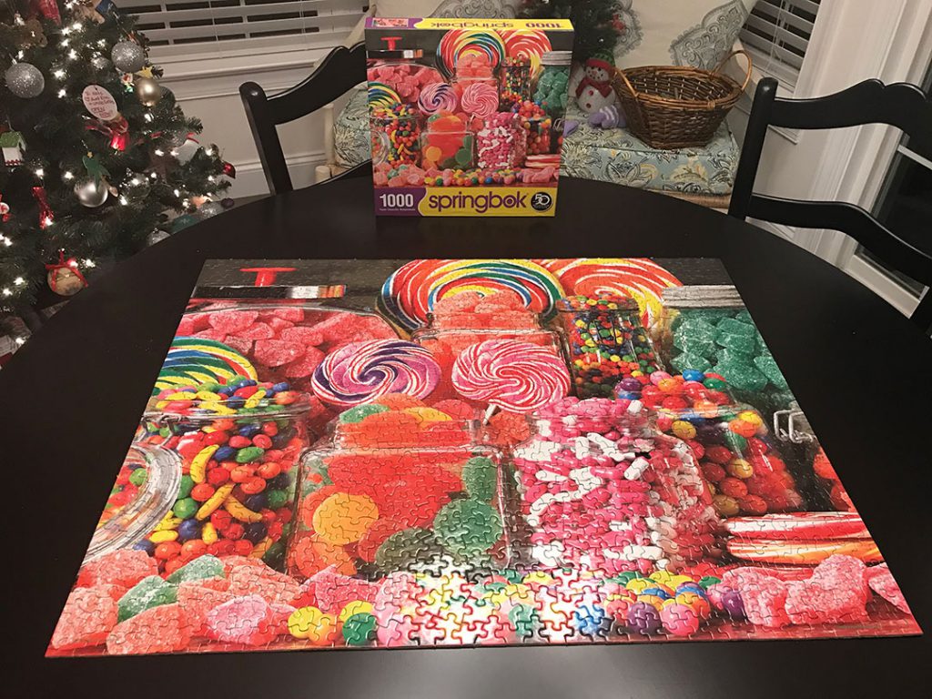 A completed puzzle with different candies printed on it.