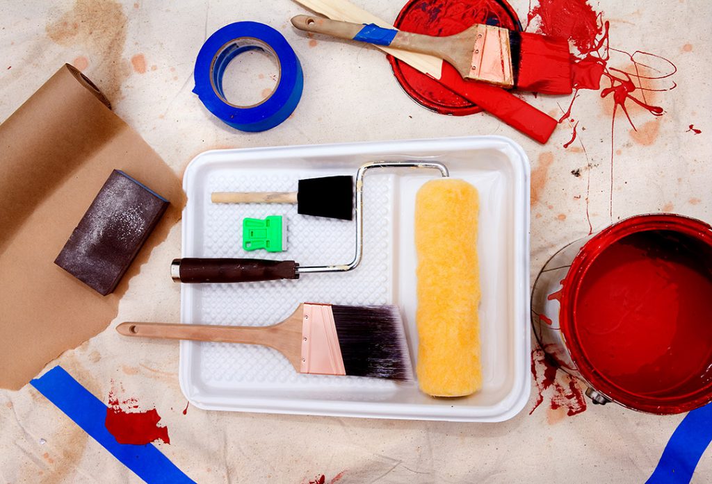 A pile of painting tools on a tarp.